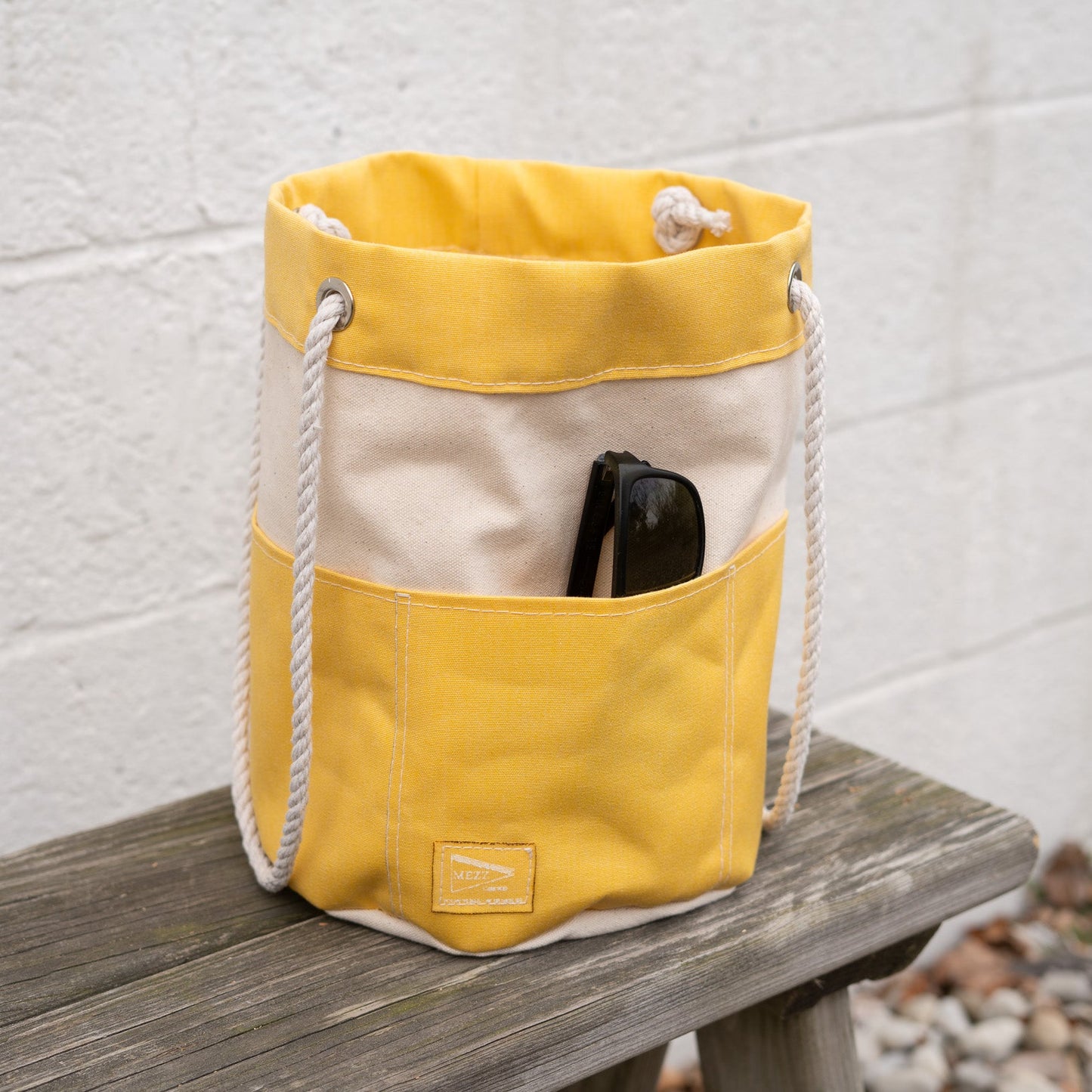 Yellow Rope Handle Bucket Bag Displaying the exterior Pockets